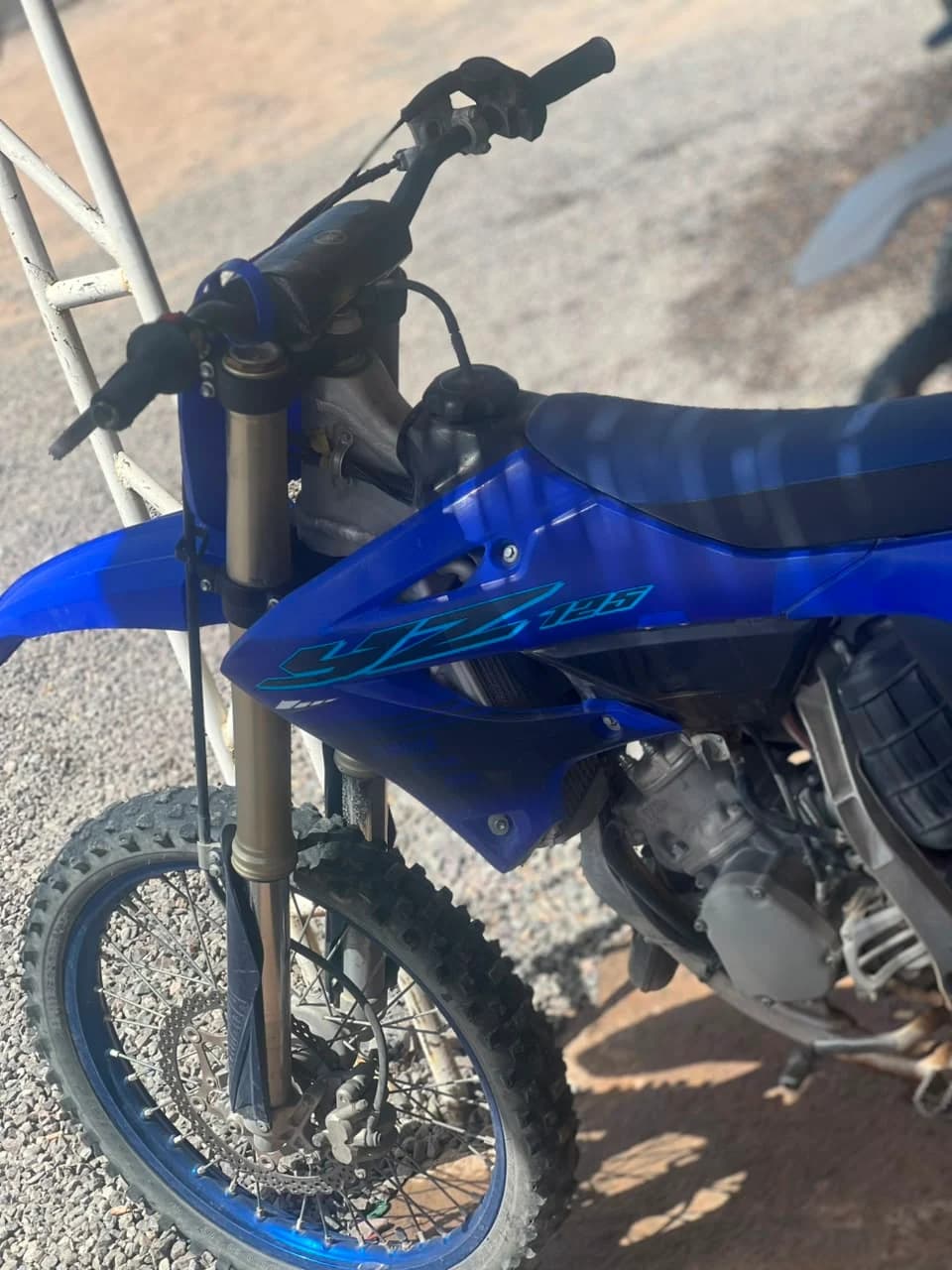 The rental business's own Yamaha YZ125 motocross bike, parked in a gravel yard