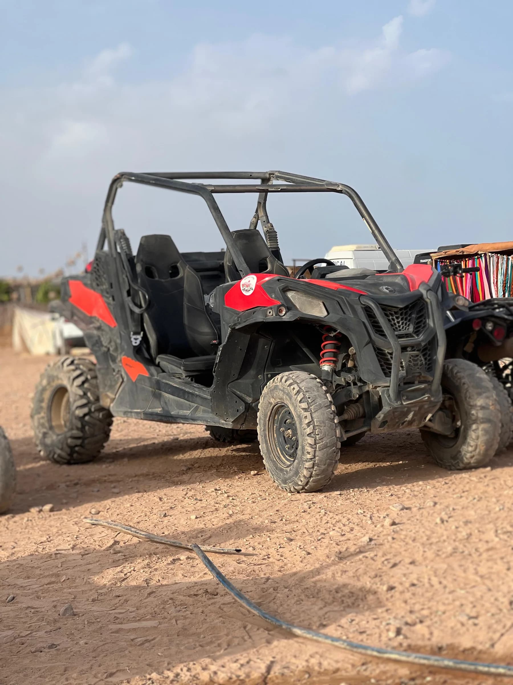 A black and red off-road buggy parked on desert terrain