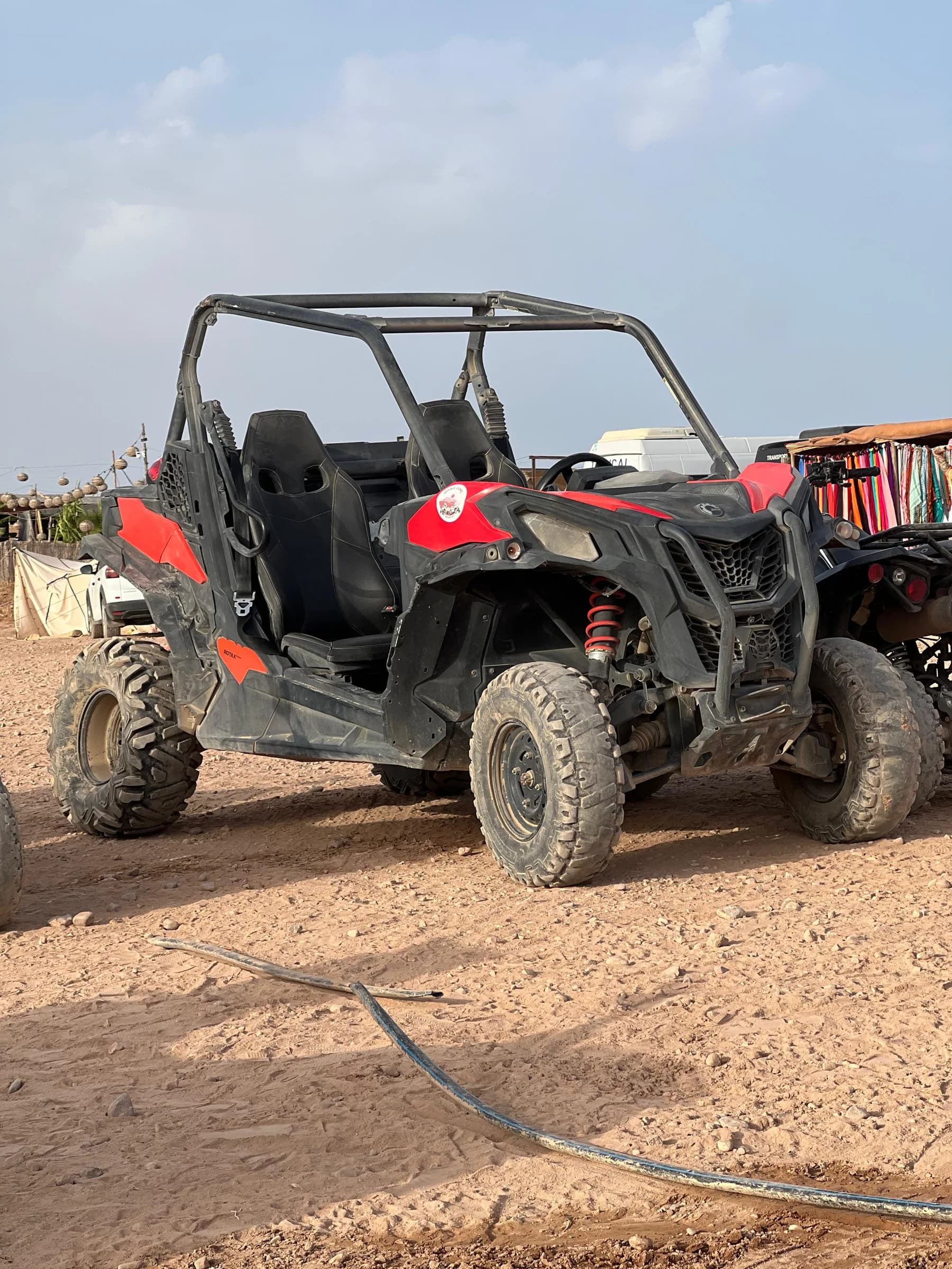 A black and red off-road buggy parked in the desert