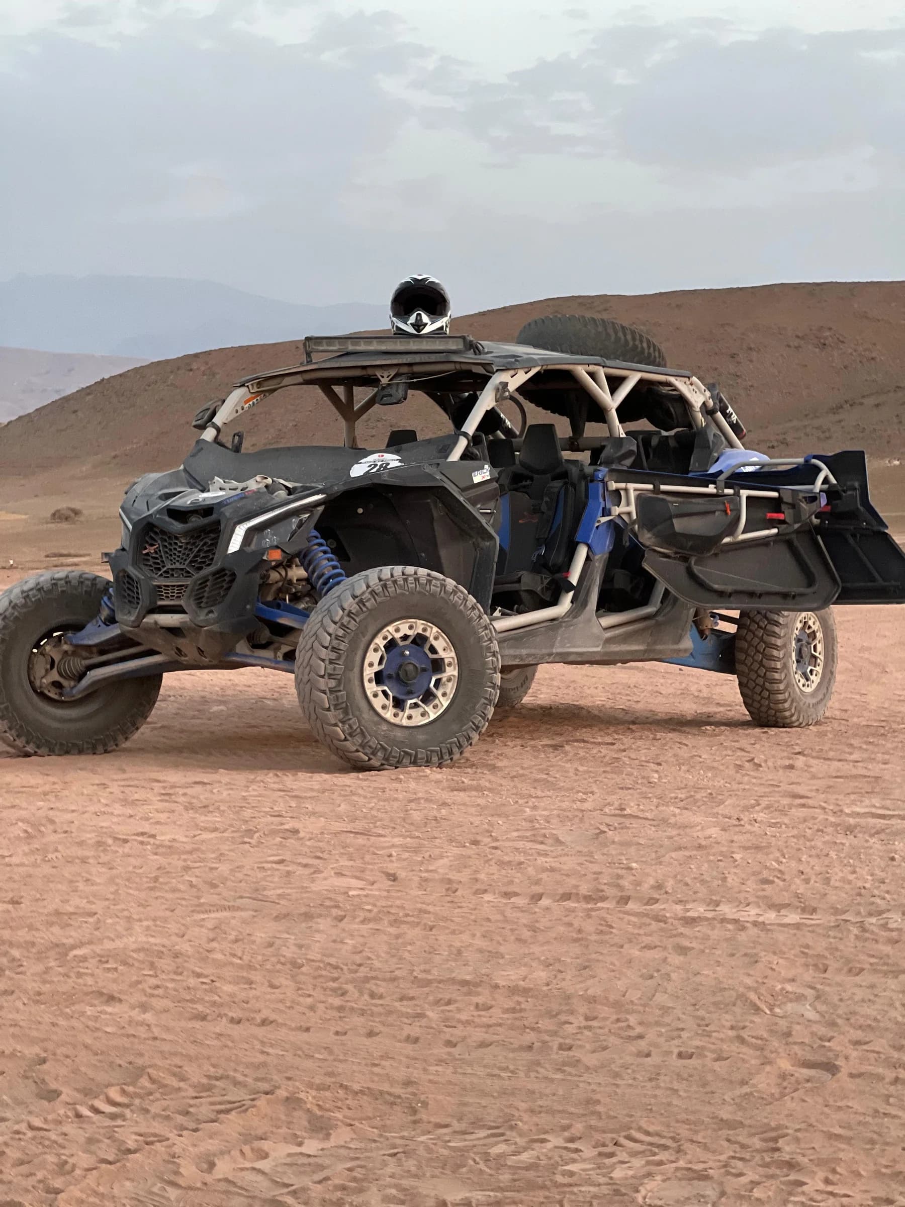 An off-road buggy parked on a sand dune