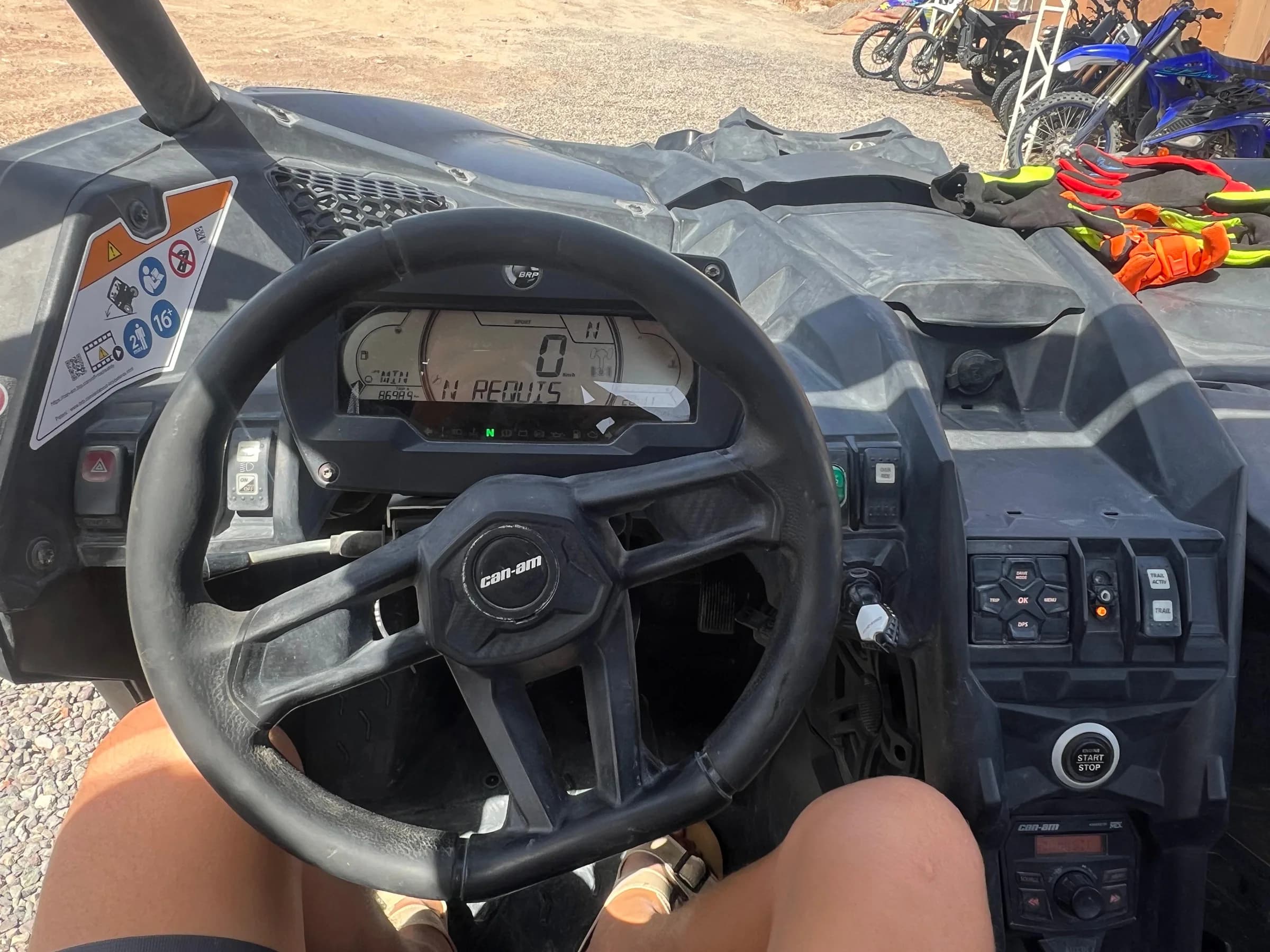 Close-up of hands on a buggy steering wheel and dashboard