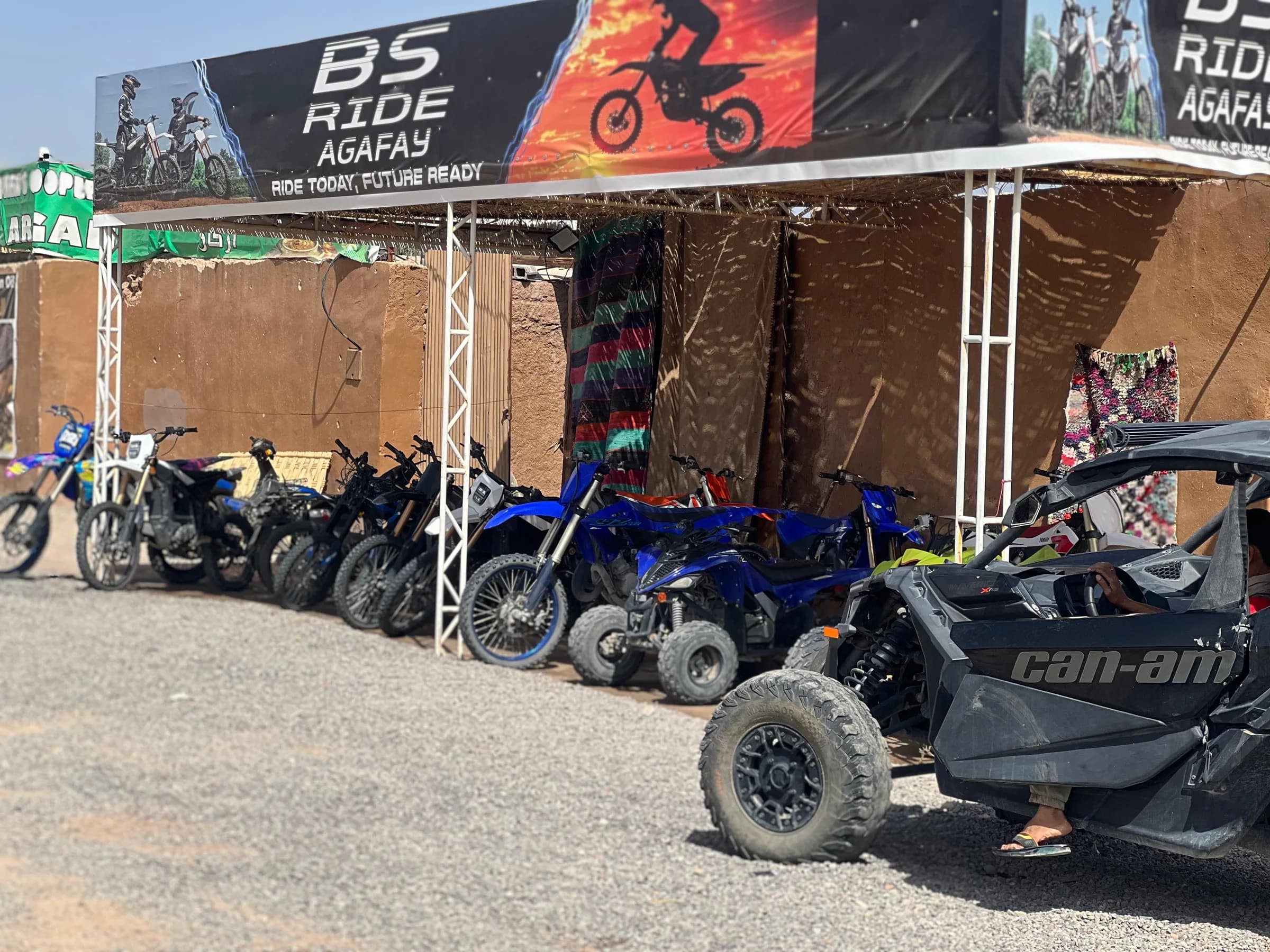 A row of quad bikes and buggies parked at the rental shop yard