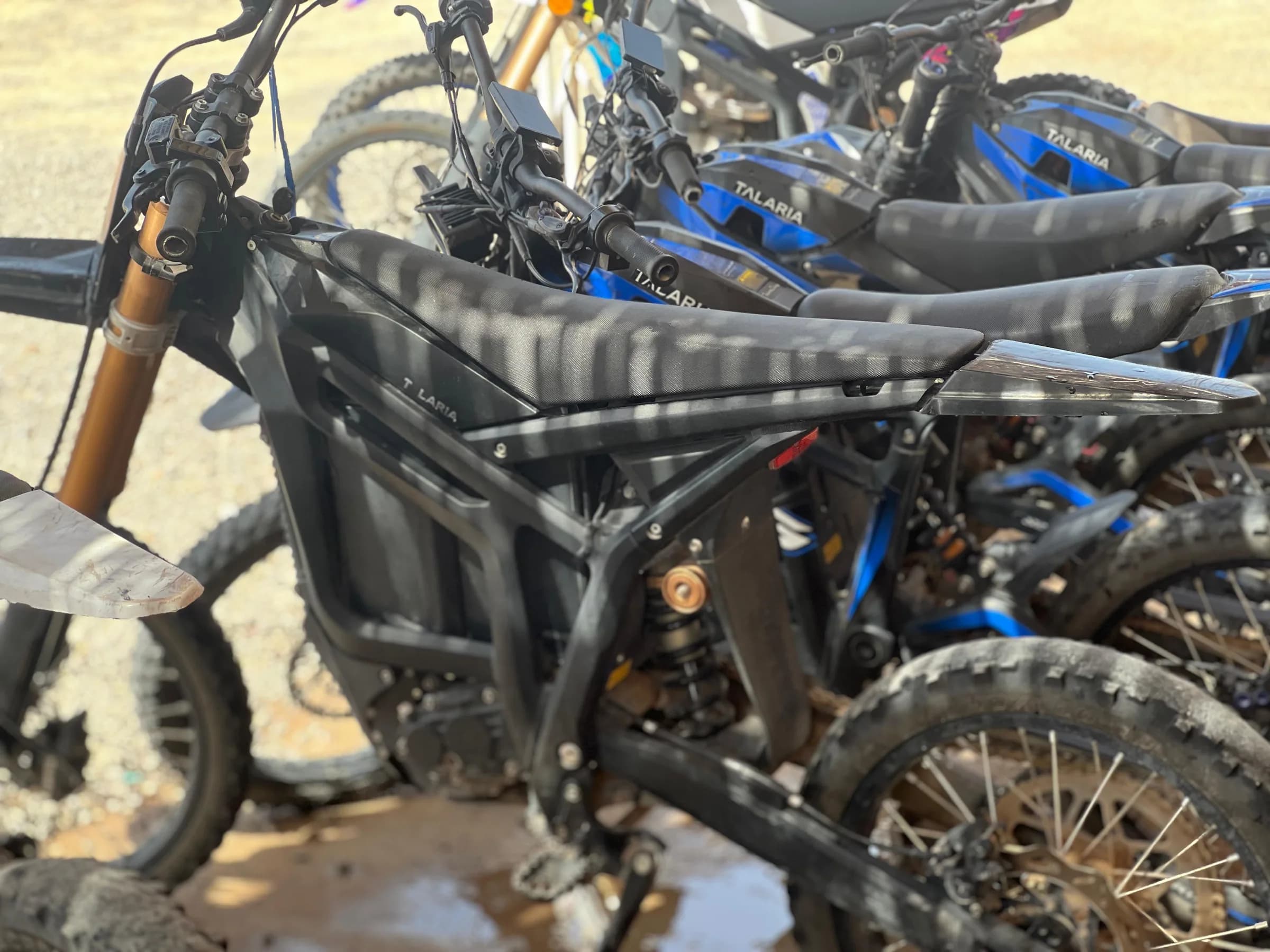Close-up of several electric dirt bikes parked together