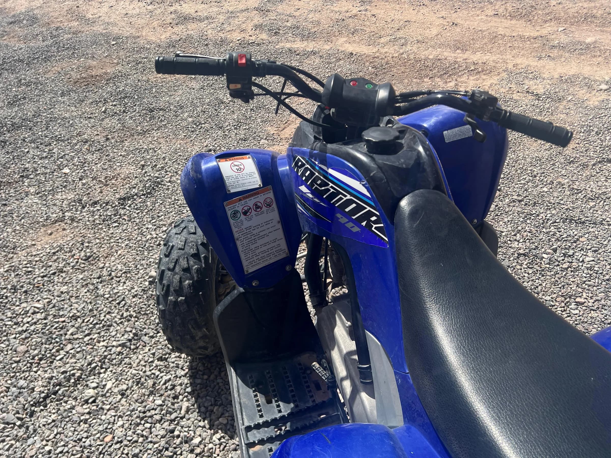 Close-up of the rear seat of a blue quad bike