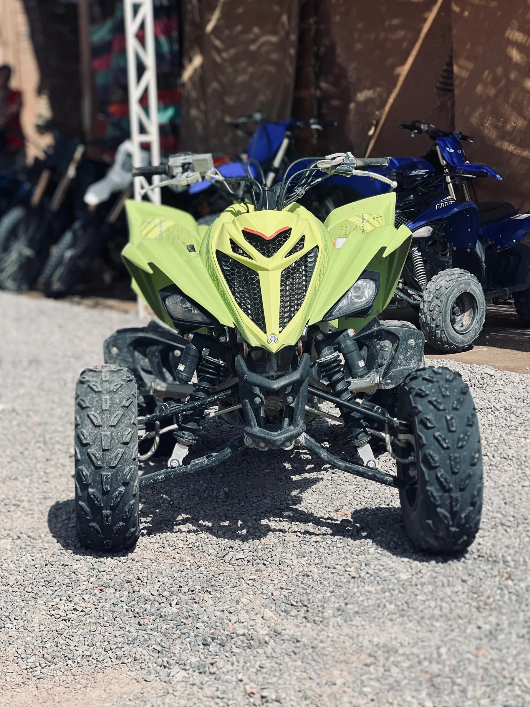 Close front view of a lime green quad bike